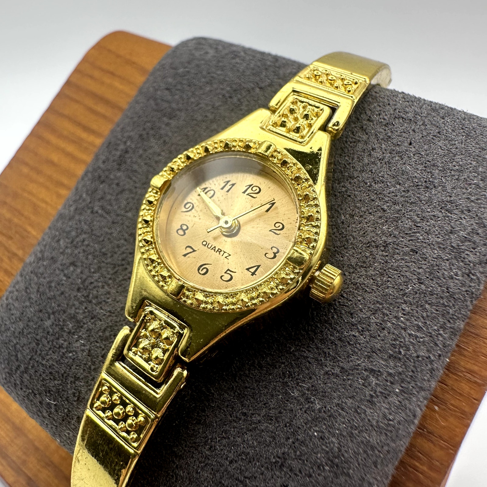 Vintage Gold Tone Quartz Bracelet Watch With Textured Bezel Oval Dial